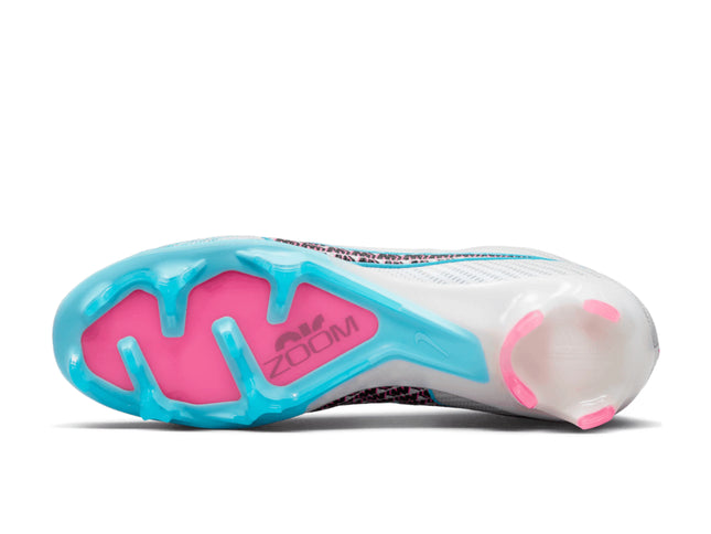 Close-up of a running shoe sole with pink and blue design on a white background
